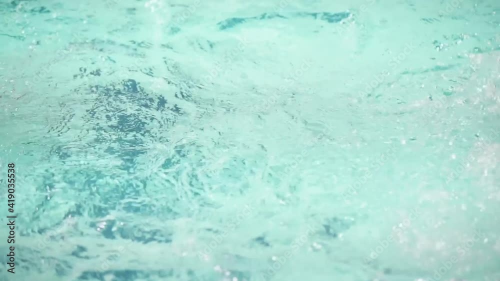 Young man swimming in swimming pool in slow motion Young man swimming in swimming pool in slow motion