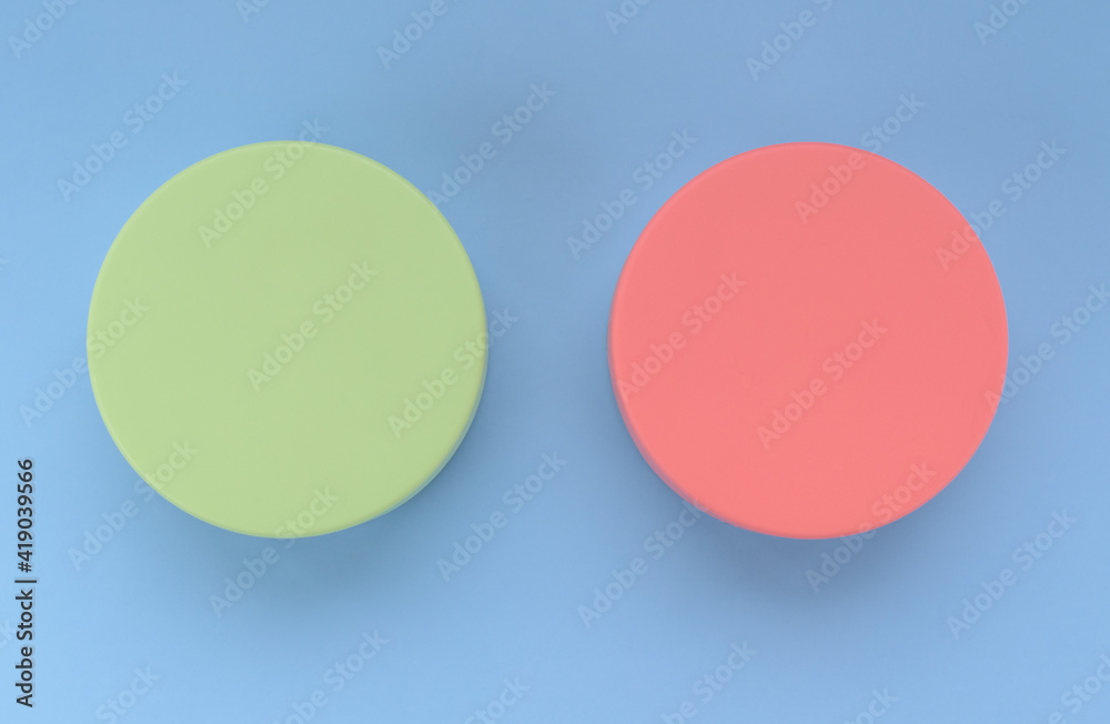 Two colored volumetric circles. Color - Sprout, Hue Green and Sea Pink, Hue Red. Background color - Portage, Hue Blue. Comparison concept, buttons, capacities.