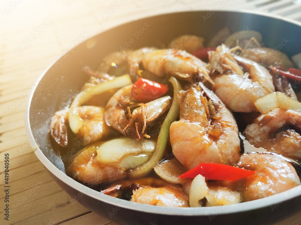 shrimp butter sauce in a pan against a wooden background. Blurry Background shrimp butter sauce in a pan against a wooden background. Blurry Background