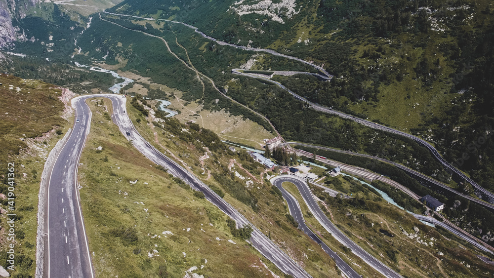 winding pass road in the Swiss Alps surrounded by mountains