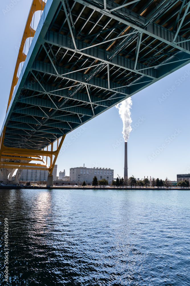 A smokestack on jones island emits water vapor into the blue sky in Milwaukee, Wisconsin
