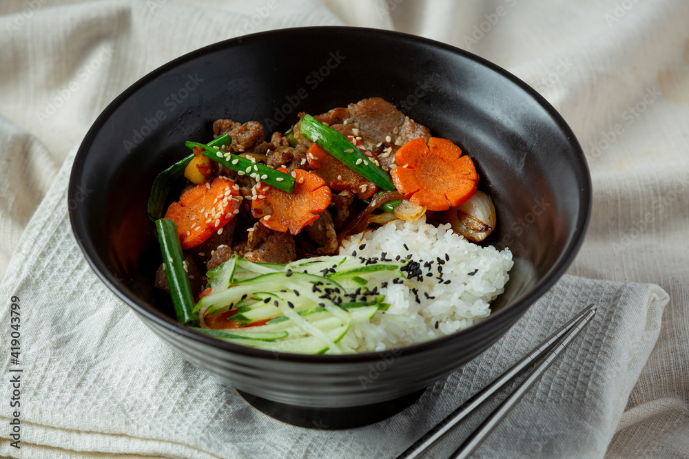 Stir Fried Pork with Korean Sauce on dark background Stir Fried Pork with Korean Sauce on dark background
