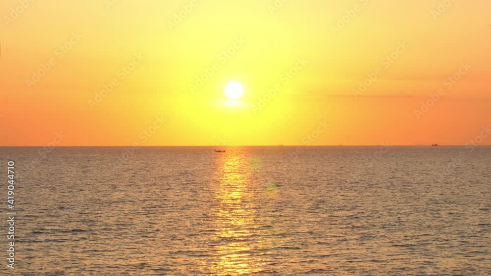 .small fishing boats sailing on horizon of the sea during beautiful golden sky .small fishing boats sailing on horizon of the sea during beautiful golden sky