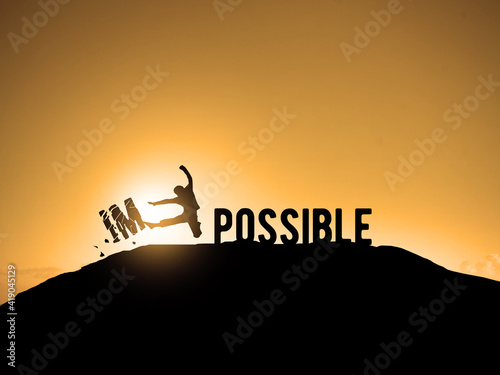 from impossible to possible young guy kicking letters IM away. success motivation positive solution concept