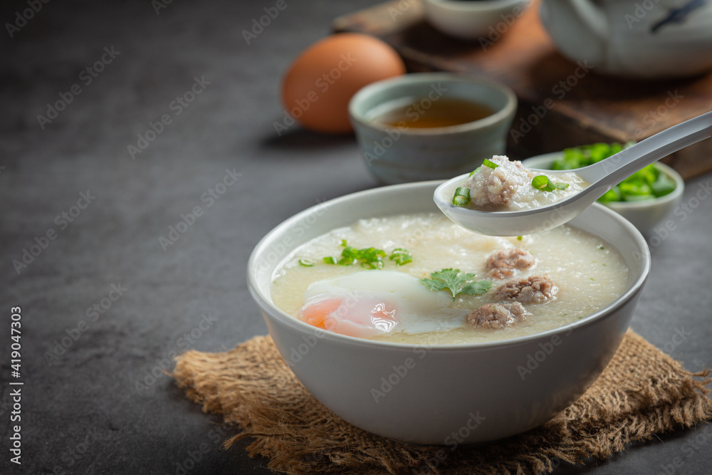 congee with minced pork in bowl on old dark background congee with minced pork in bowl on old dark background