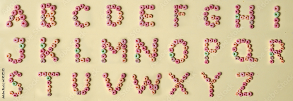 Letters of colorful donut alphabet from A to Z isolated on beige ...