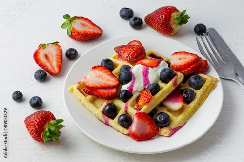 Waffles, strawberries, blueberries with yogurt