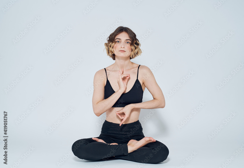 Woman meditates on a light background yoga asana Woman meditates on a light background yoga asana