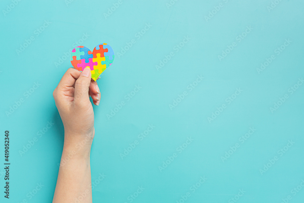child hands holding jigsaw puzzle heart shape, Autism Day child hands holding jigsaw puzzle heart shape, Autism Day