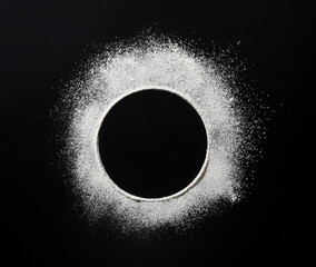Abstract background. Black background with round dots sprinkled with flour circles.