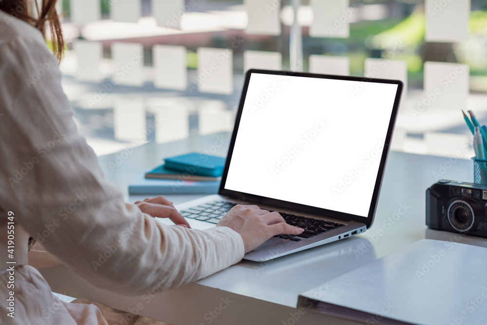 Mock up. Woman hand printing jobs using a laptop keyboard at the office. Mock up. Woman hand printing jobs using a laptop keyboard at the office.