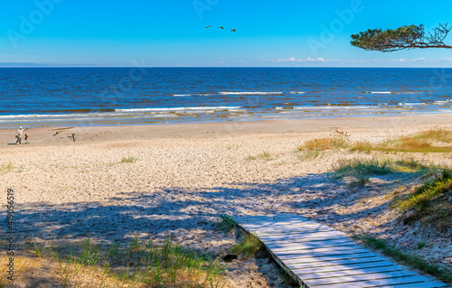 Wooden footpath leading to sandy beach of the Baltic Sea in Jurmala - famous ...