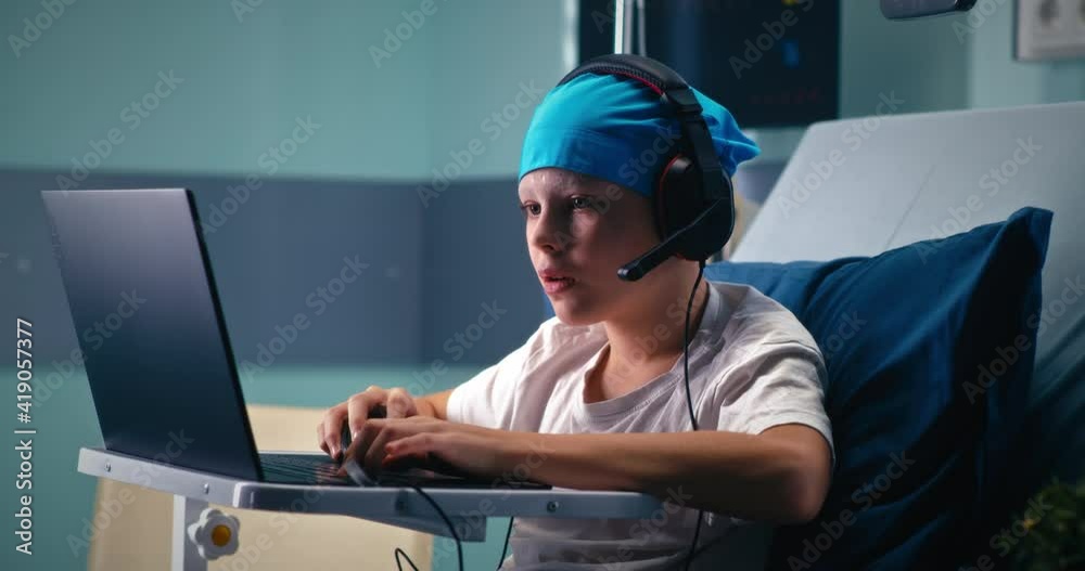 Little gamer winning videogame in hospital ward Little gamer winning videogame in hospital ward