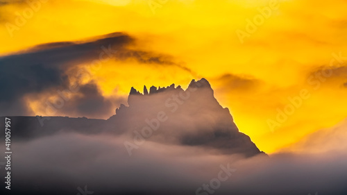 Mountain peak in the fog at sunset © Vastram
