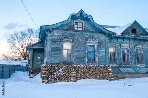 Blue house with wooden carvings in Porechye, Russia photo