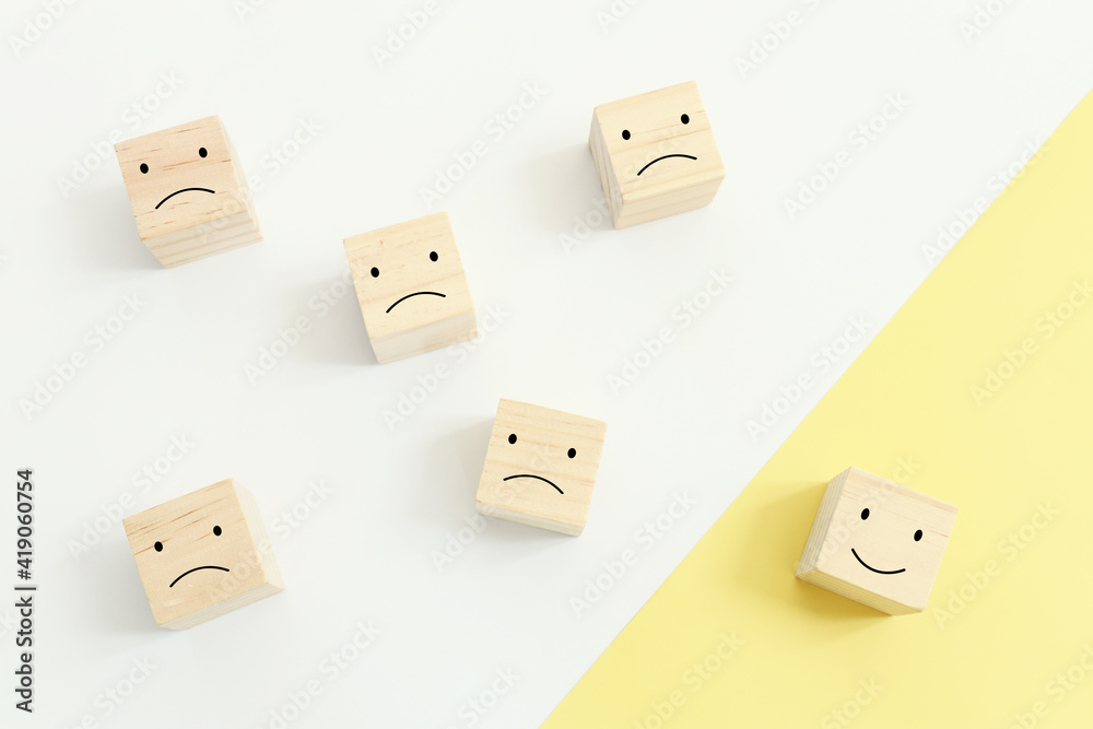 Concept image of satisfaction level. wooden cubes with emotions Concept image of satisfaction level. wooden cubes with emotions