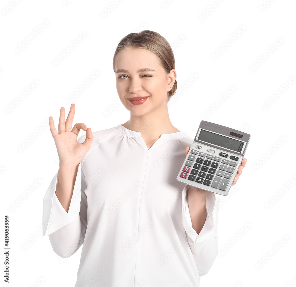 Young woman with calculator showing OK gesture on white background Young woman with calculator showing OK gesture on white background