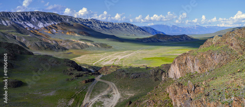 Dry Mongolian landscapes in the Altai Mountains, wide view. Country road in the valley, contrast © Valerii