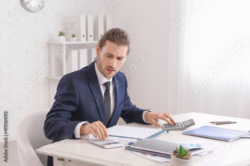 Male accountant with calcul...