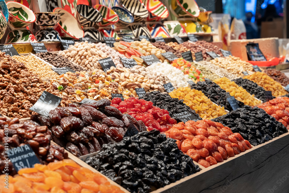 Obraz premium Market counter with various assorted dried fruits and nuts. Healthy food. Local market place.