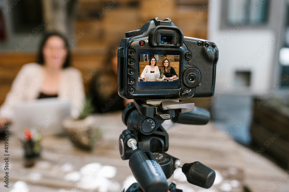 Screen of camera recording a tow Mexican women bloggers talking while making a video in a creative office in Mexico city