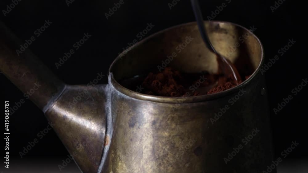 Preparation of Turkish coffee. Cezve with a running coffee . Running coffee close up