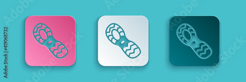 Paper cut Human footprints shoes icon isolated on blue background. Shoes sole. Paper art style. Vector.