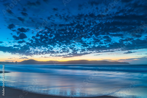 Sunrise seascape at the beach with haze and cloud