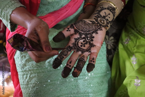 New Delhi, Delhi India- February 28 2021: Drawing traditional tattoo on hands- Mehndi. photo