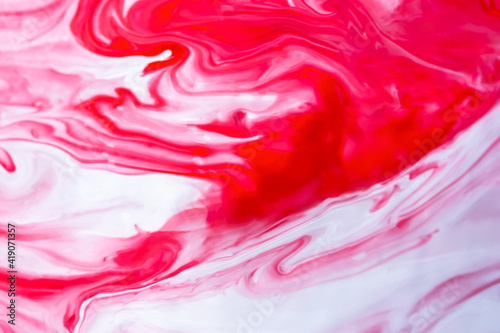 Red and white fluid art, abstract creative background with acrylic paints. Dynamic lines, free movement, outburst of emotions, passion, free natural form. The concept of strawberries with cream.