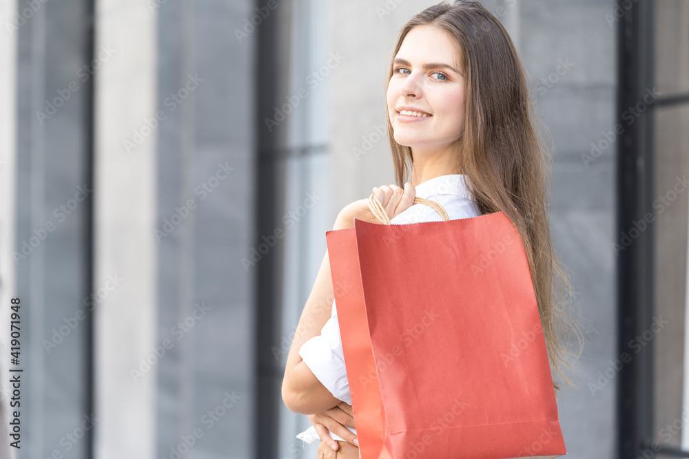 Shopping and fun concept. Beautiful woman walking with shopping bags in the city. Shopping and fun concept. Beautiful woman walking with shopping bags in the city.