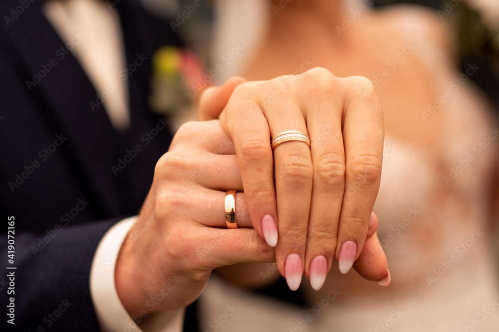Picture of man and woman with wedding ring holding fingers Picture of man and woman with wedding ring holding fingers