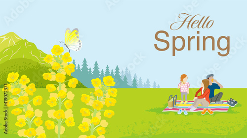 Young family enjoying picnic in springtime nature - Included the word "Hello Spring"