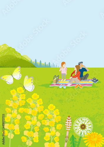 Young family enjoying picnic in springtime nature, vertical layout