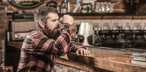 Beer time. Man drinks beers at the bar counter. People, lifestyle, recreation. Man with beer. Bearded hipster holds glass of beer. Beer pub. Stylish guy at cafe pub
