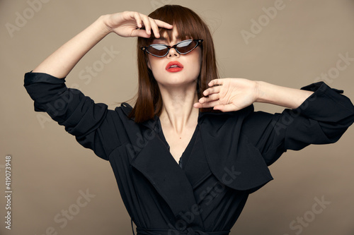 Sexy woman gestures with her hands near her face elegant appearance 