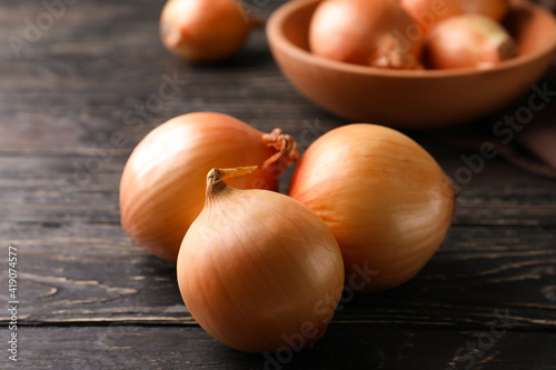 Ripe fresh onion on wooden background  close up