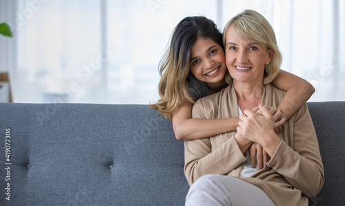 Happy teen girl embracing foster mother