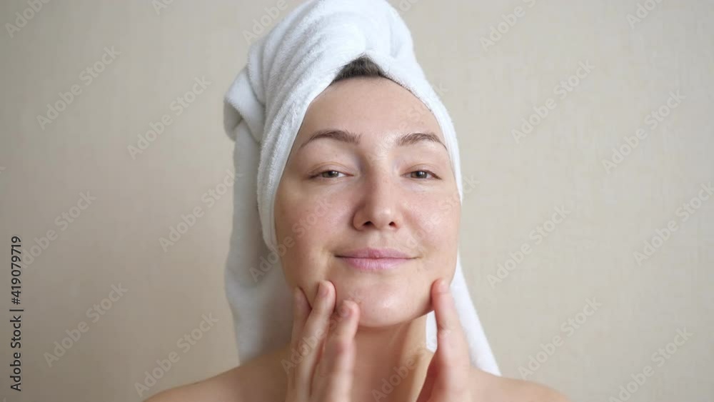 Young woman makes herself a finger massage of face. Young woman makes herself a finger massage of face.