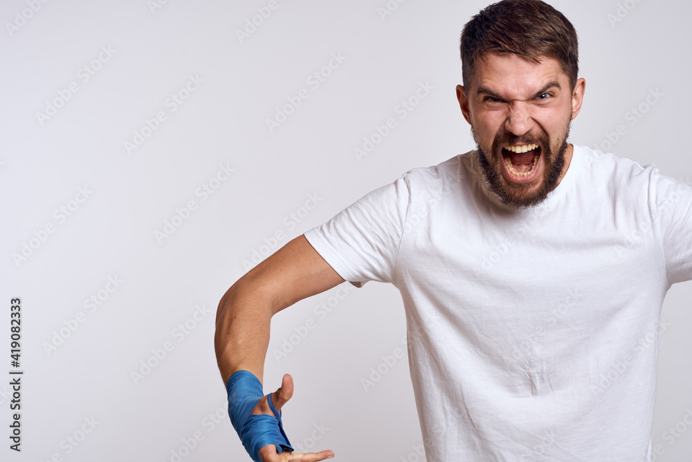 Sports man boxing bandages on hands emotions energy workout