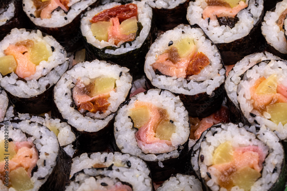 Top view of stack of Japanese sushi maki roll plate. Served in Japanese bar restaurant with chopstick Top view of stack of Japanese sushi maki roll plate. Served in Japanese bar restaurant with chopstick