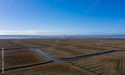 Luftaufnahme vom Leuchtturm von Westerhever mit Wattenmeer und Nordseeküste, Schleswig Holstein, Deutschland photo