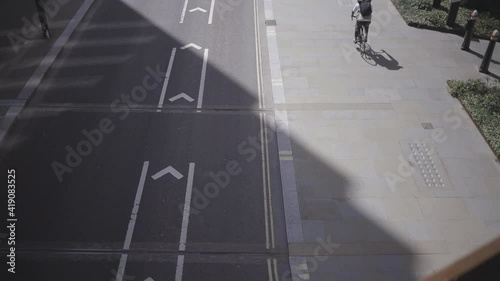man cycling in the city on a summers day. Slow motion 50fps conformed to 25fps photo