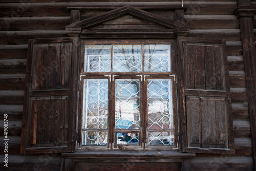 traditional ornament.  windows with wooden carvings on the windows in a wooden house © Konstantin Ivshin