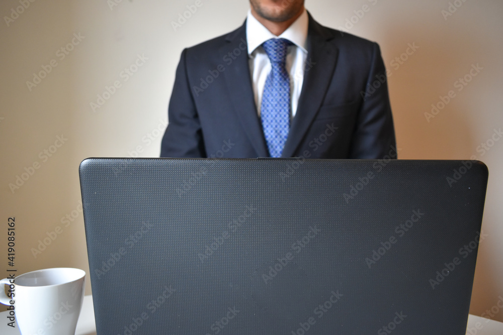 businessman wearing a suit and working with a portatail from home businessman wearing a suit and working with a portatail from home
