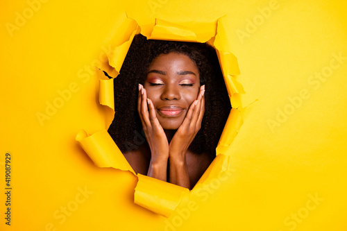 Photo of beautiful attractive lady palms cheekbones closed eyes isolated ripped vibrant yellow color background