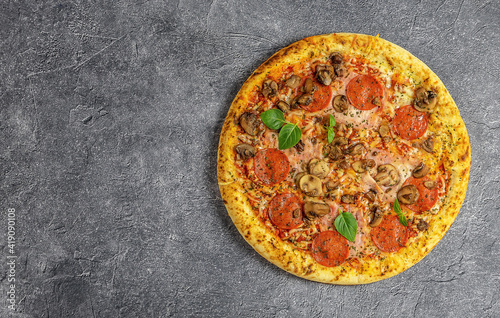 Whole neapolitan pizza served on dark board