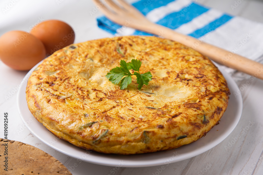 Traditional Spanish omelette with potatoes and zuuchini Traditional Spanish omelette with potatoes and zuuchini