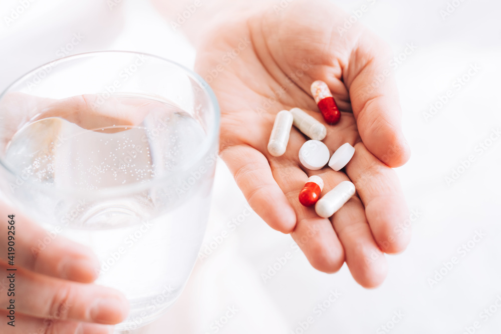 Medical pills tablets lie in woman's hand. Health and medicine. Selective focus Medical pills tablets lie in woman's hand. Health and medicine. Selective focus