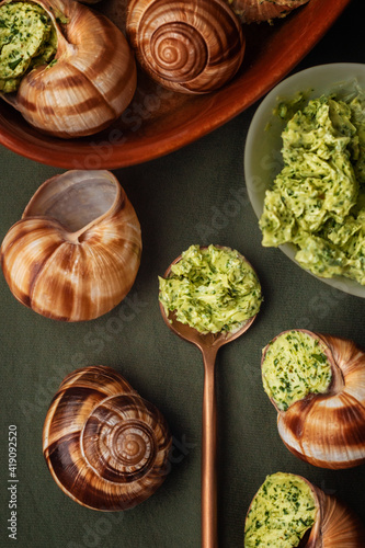 escargot stuffed in sauce on a green table